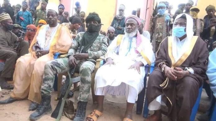 Kaduna-based Muslim Sheik Ahmed Gumi (third from left in white), Bello Turji second from left in fatigues, and sitting with bandit leaders and clerics at the bandit hideout in Niger State in February 2021. Photo courtesy of the bandits.