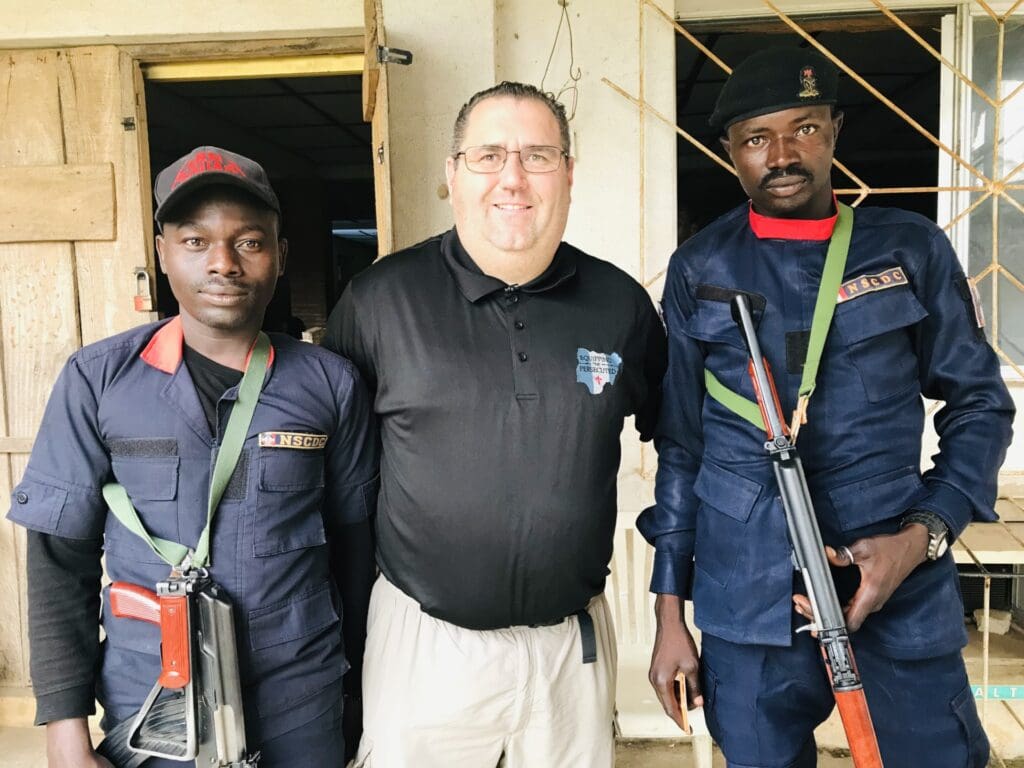 NGO operator Judd Saul, center, standing with his security team in Abuja in early 2023.  Courtesy of ETP.