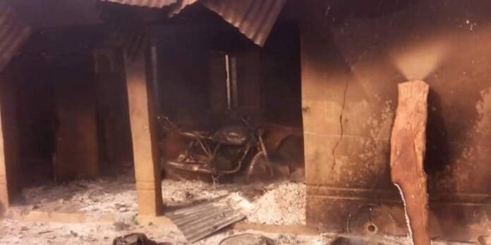 Burnt buildings in Gindin Duste from Sunday morning attacks. St Dominic Catholic Church can be seen with its humble cement row of seats with receding flames in the burnt Church (Credit: Facebook)