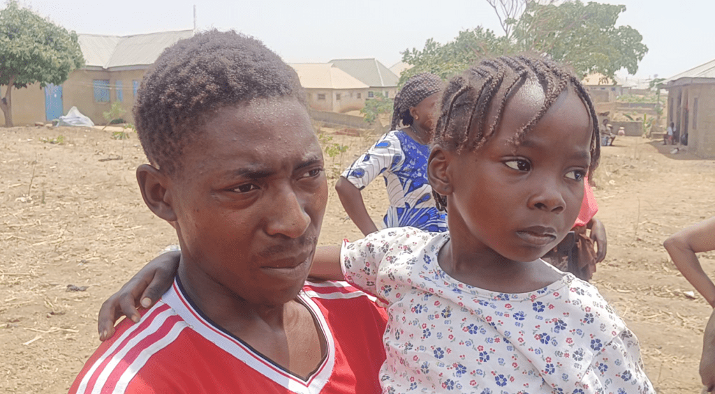 Five-year-old Helen Iremiren held by her uncle after getting left in the forest by kidnappers who abducted her father, mother and three siblings, Wednesday night. 14 people in total were marched into the forest. Helen was found roaming the forest alone by citizen guards in the early hours of Feb. 29. Courtesy of Ehis Ehouna.