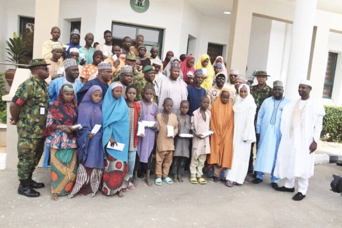 The rescued victims with Katsina State authorities. Photo credit: X/@HQNigerianArmy.