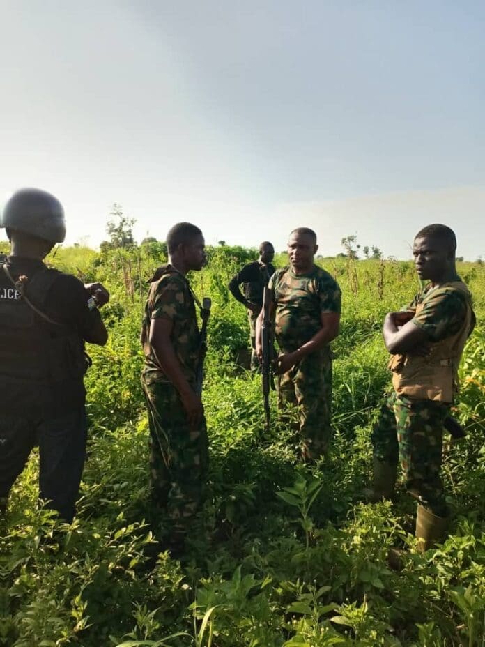 Civilian Defense Force policemen search for corpses after an overnight attack by terrorists in Benue's Guma County in May 2023. Credit Nigerian Army.