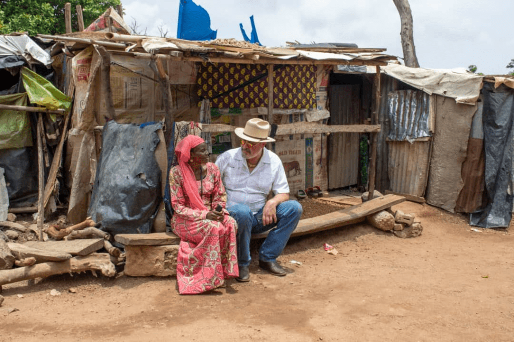 Left: Ms Hanatu Ango, an Internally displaced person from Gwoza, and Mike Arnold, NGO founder, right.  Ms. Hanatu and her three daughters ended up here in 2014 along with hundreds of other IDPs and have been stuck here ever since, Arnold tells TruthNigeria. Ms. Hanatu built the shanty herself and teaches school at the camp. 

