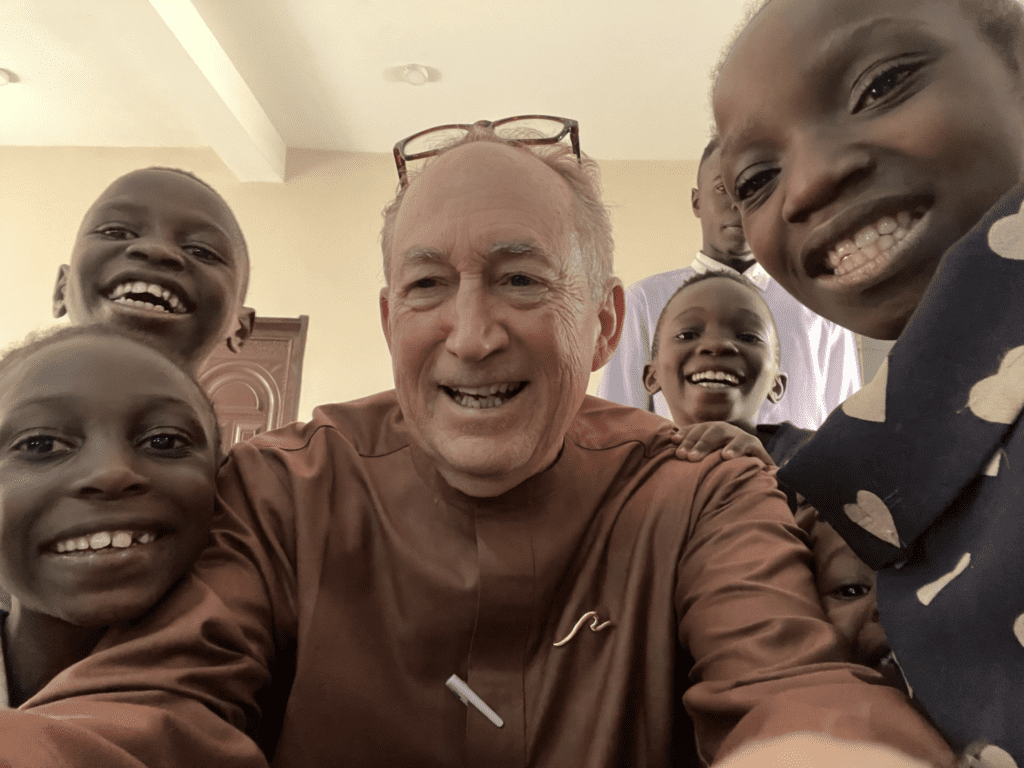 Managing editor Douglas Burton taking a selfie with students at Paradise School for children.