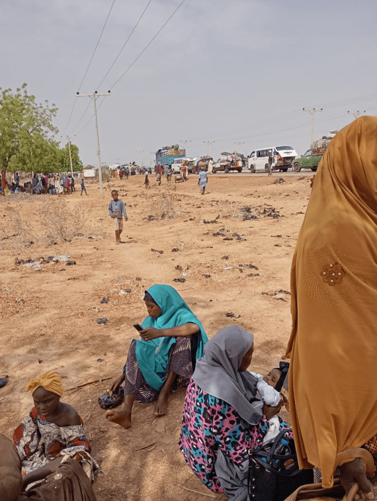 Highway scene through Sambisa Forest in Borneo, showing slow-moving traffic preceded by mine sweepers clearing bombs planted by ISWAP and Boko Haram. Credit Mike James.