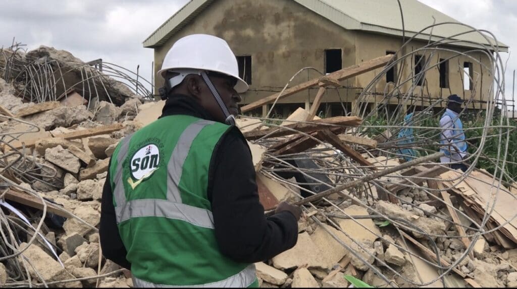 An investigator from the Standards Organization of Nigeria (SON) analyzing evidences at the collapse site. credit: Masara Kim.