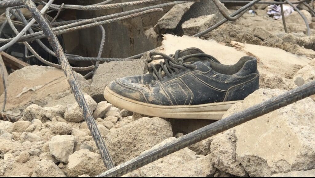 A shoe apparently belonging to a student seen in the ruins of the collapsed school: Credit: Masara Kim. 