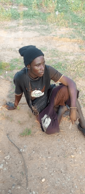 Suspected terrorist, waiting on bank. credit: Mike Odeh James.