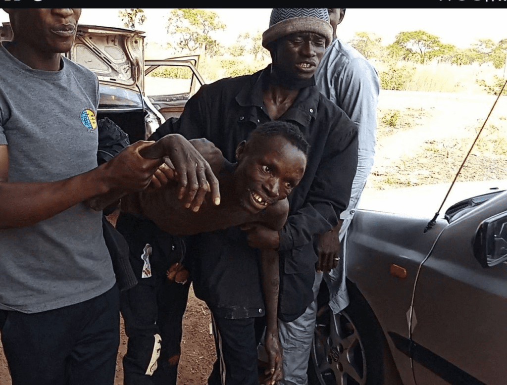 Mr. Jibril Zephaniah, weakened by 90 days of starvation, assisted by Simon Nuhu to board a rescue vehicle on Feb. 23, 2025. credit: Mike Odeh James.