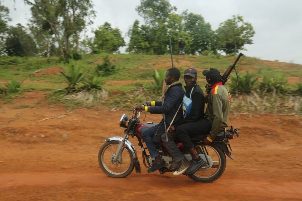 Civilian guards armed with homemade single-shot pipe guns patrol a part of Bokkos on motorcycle. Credit Masara Kim.