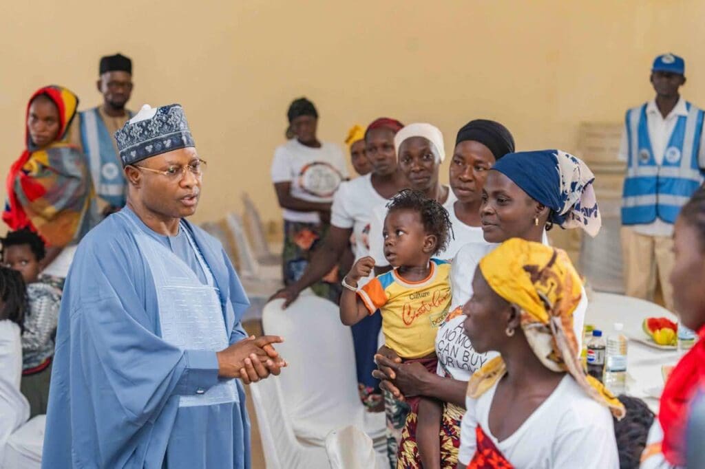 Governor Uba Sani of Kaduna State (in blue embroidery cap and flowing gown) speaking to some of Kurmin Wali Villagers at Kaduna Children Centre, Kaduna, Wednesday. They were taken there after escaped being kidnapped and spent over ten days wondering in the bushes and taking shelter among other communities before returning to Kurmin Walli (Credit: Uba Sani Facebook)