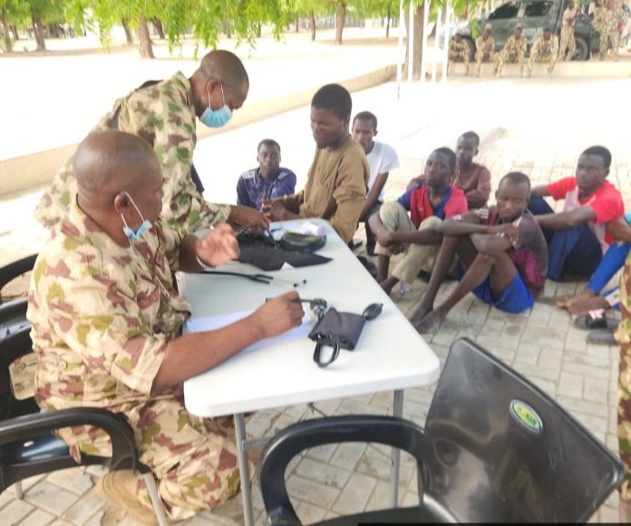 Soldiers attending to students of the Federal Polytechnic, Monguno following a foiled mass abduction attempt at the Federal Government Girls College in Monguno, Borno State. Photo: Facebook/@HQ Nigerian Army.